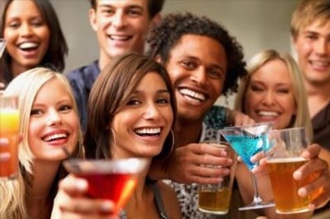 A group of people holding drinks and smiling.