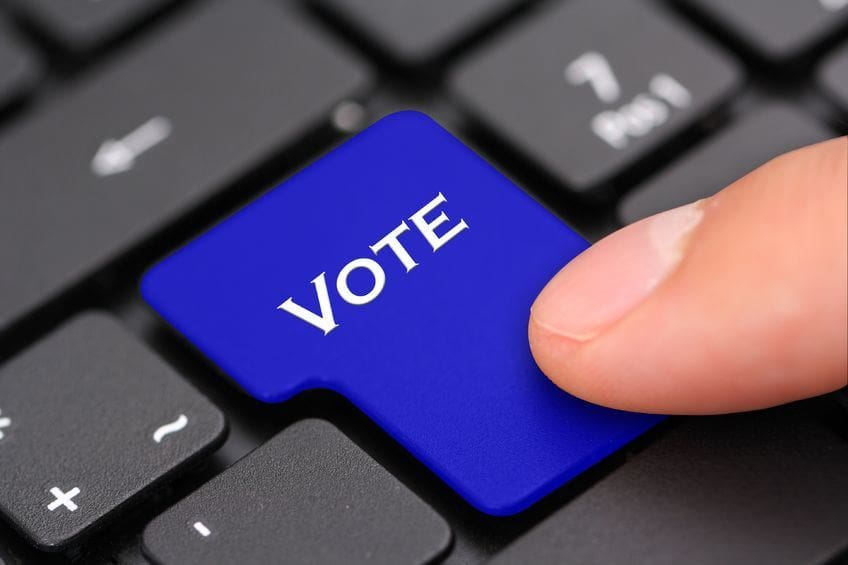 A person pressing the button to vote on a keyboard.